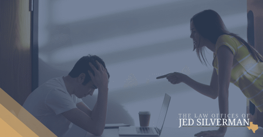 young woman pointing finger at young man who is holding his head in his hands looking down