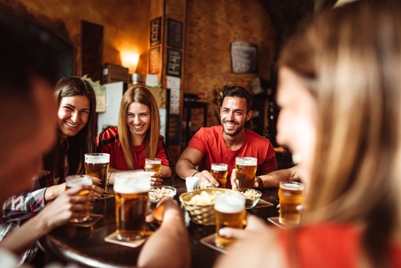 Friends drinking beer at a local bar