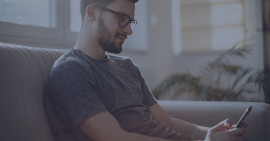young student using social media on his phone